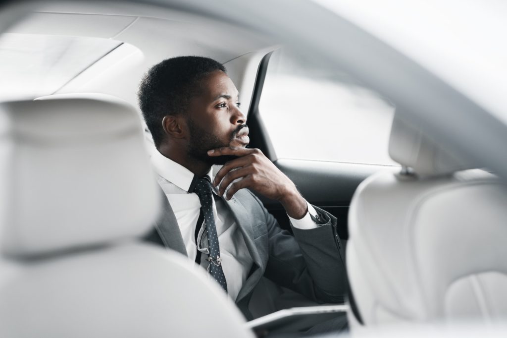 Thinking about solutions. Thoughtful businessman sitting in car