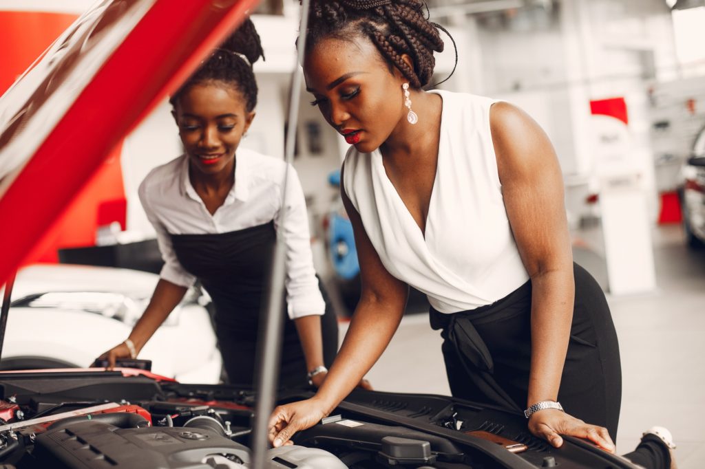 Two stylish black women in a car salon