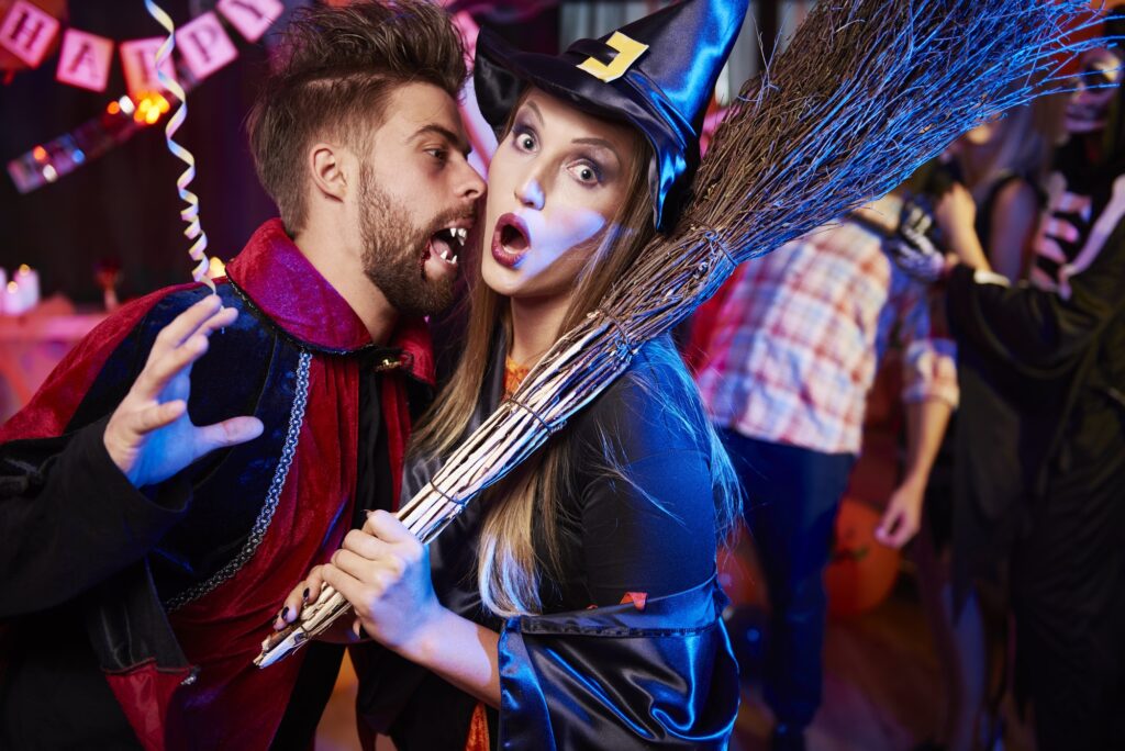Vampire and witch at Halloween party