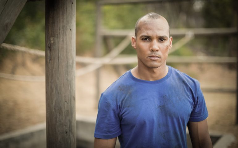 Portrait of determined man standing during obstacle course
